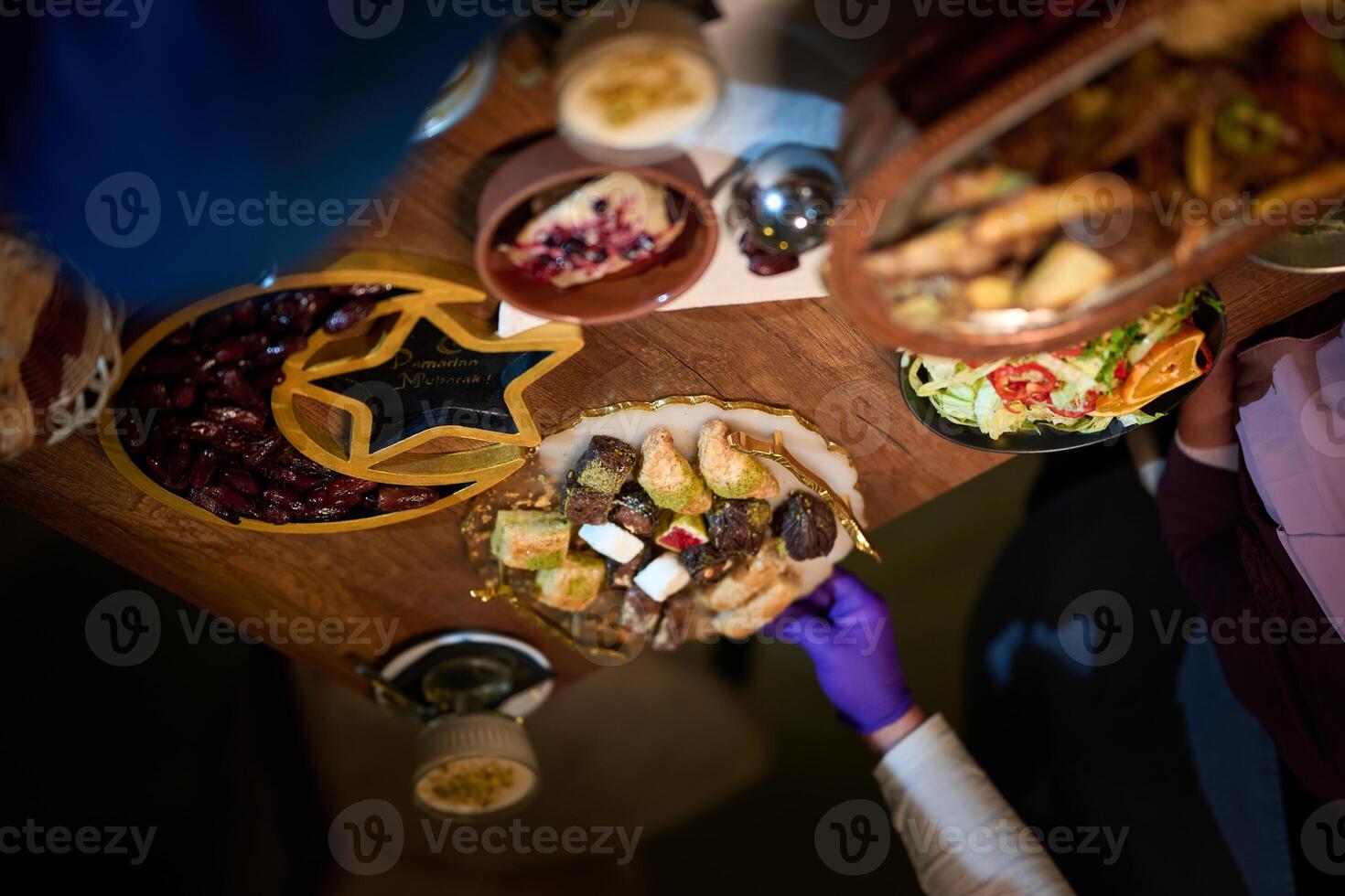 In this captivating aerial view, delicious food adorned with Ramadan decorations, including dates and meat, awaits the arrival of an European Islamic family, promising a festive and flavorful iftar photo