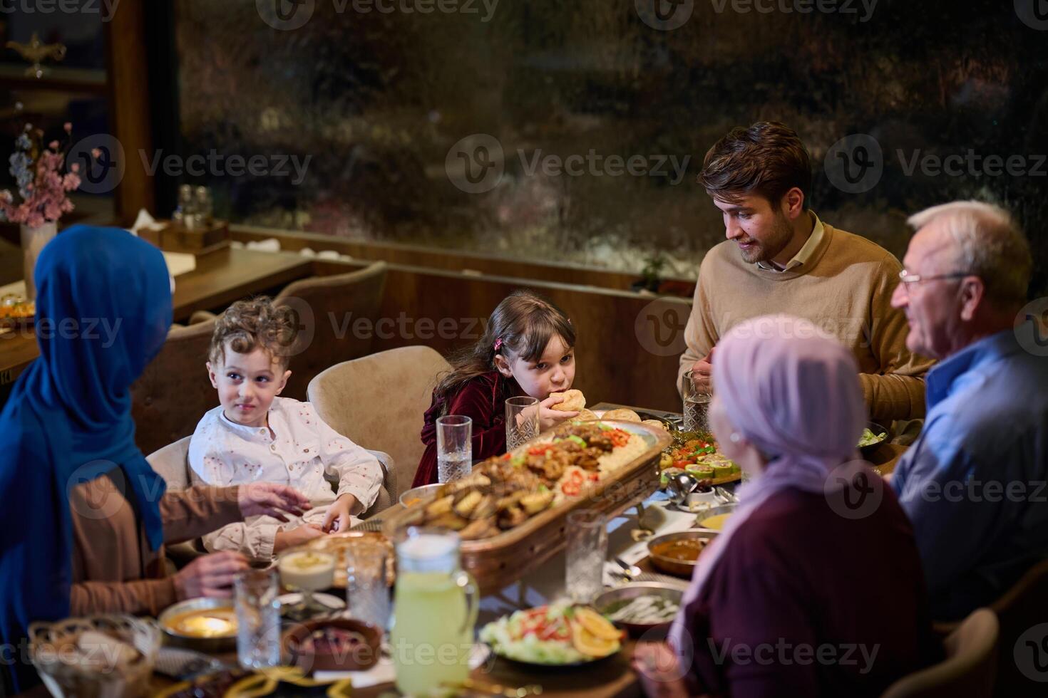 A modern and traditional European Islamic family comes together for iftar in a contemporary restaurant during the Ramadan fasting period, embodying cultural harmony and familial unity amidst a photo
