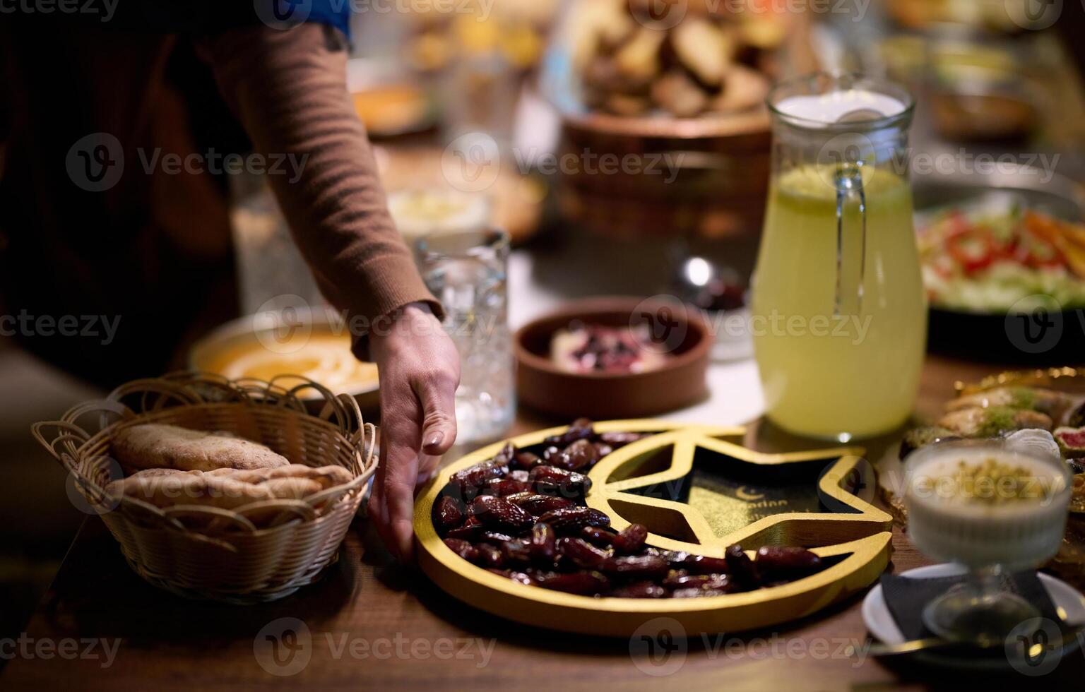 In this modern portrayal, a European Islamic family partakes in the tradition of breaking their Ramadan fast with dates, symbolizing unity, cultural heritage, and spiritual observance during the holy photo