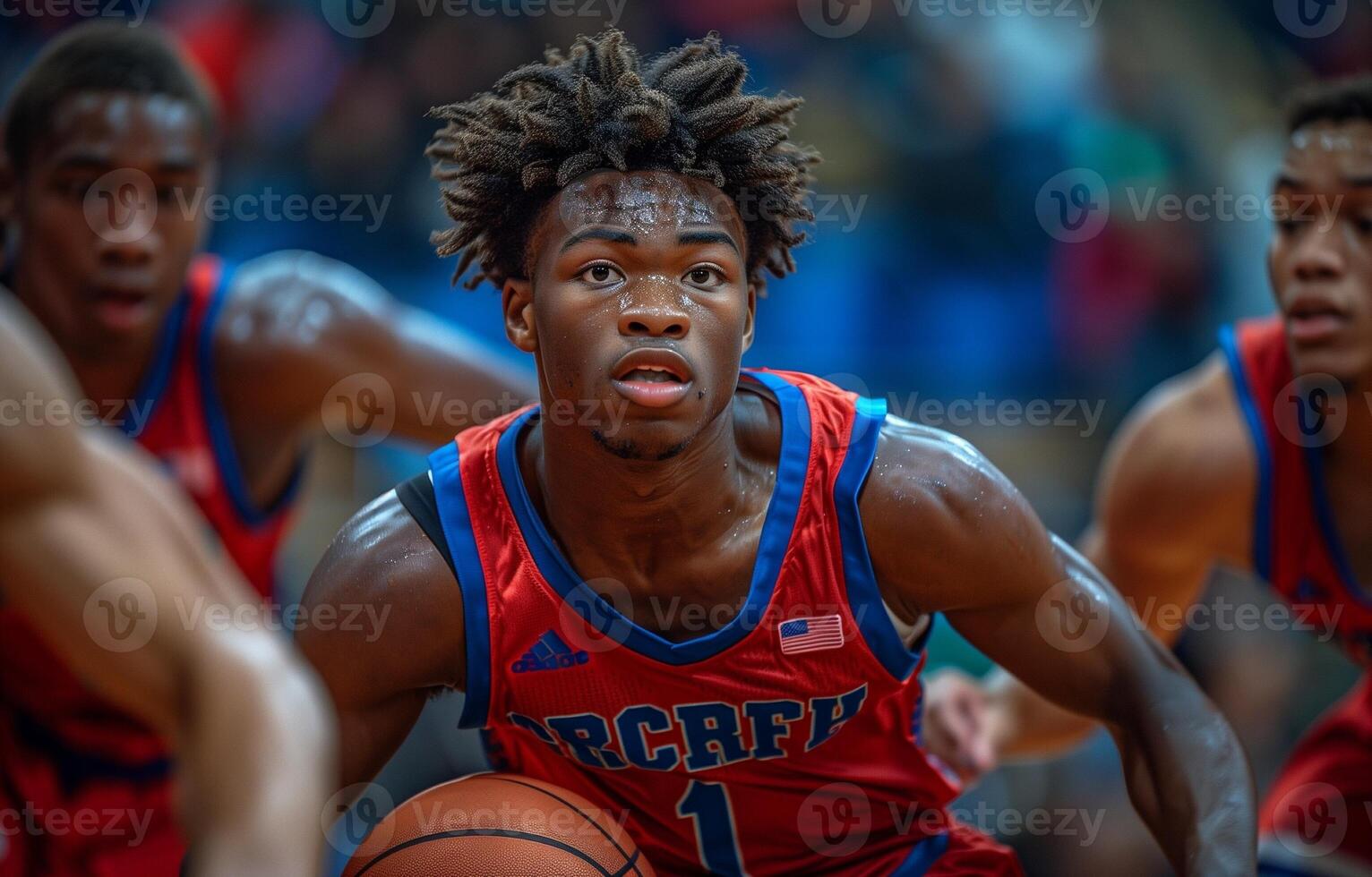 Three young men play basketball in a gym. One dribbles past three defenders, all in red and blue uniforms photo