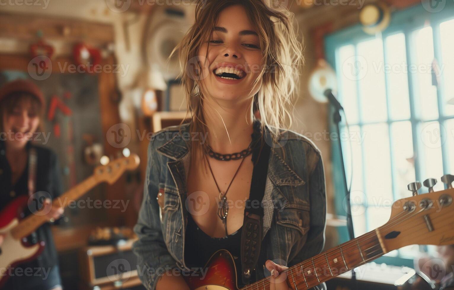 Female rock band performing and singing in a home studio, laughing and enjoying their music together photo