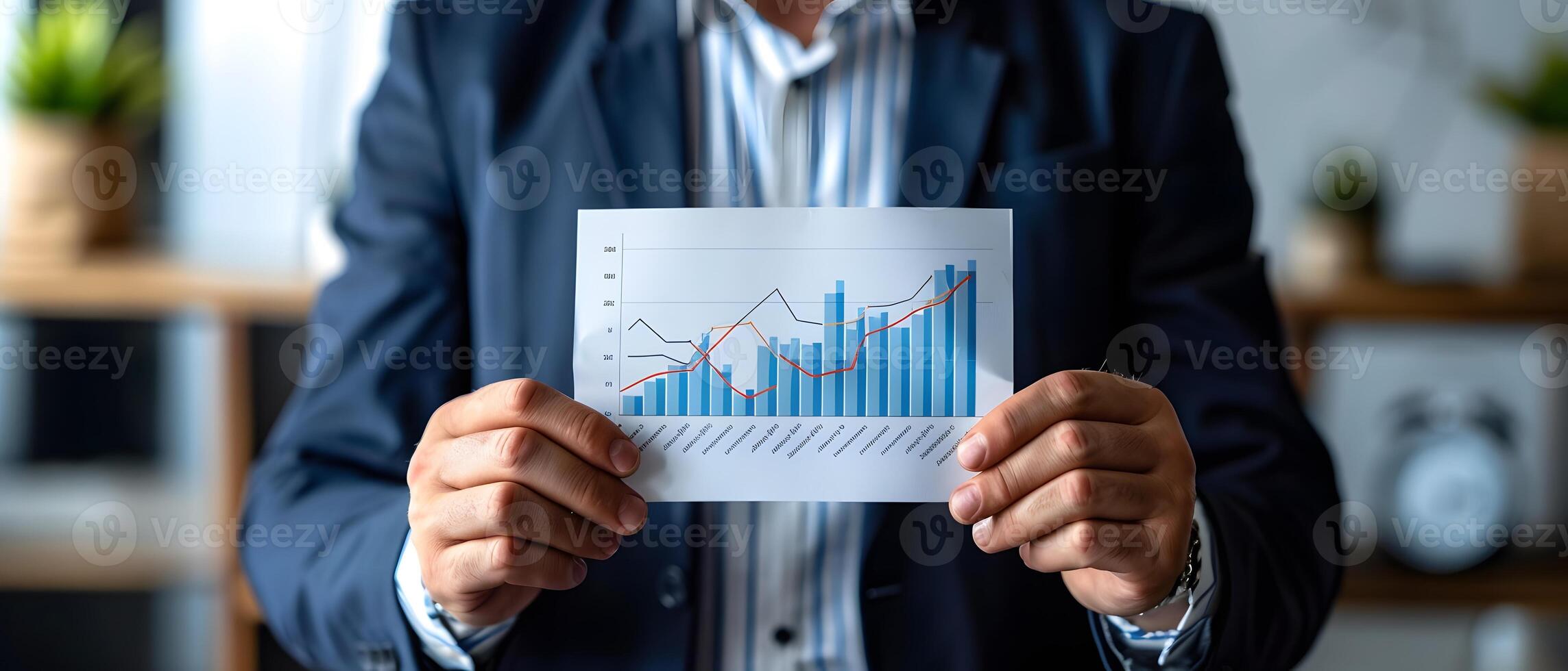 A person holding a paper with a graph, close-up view photo