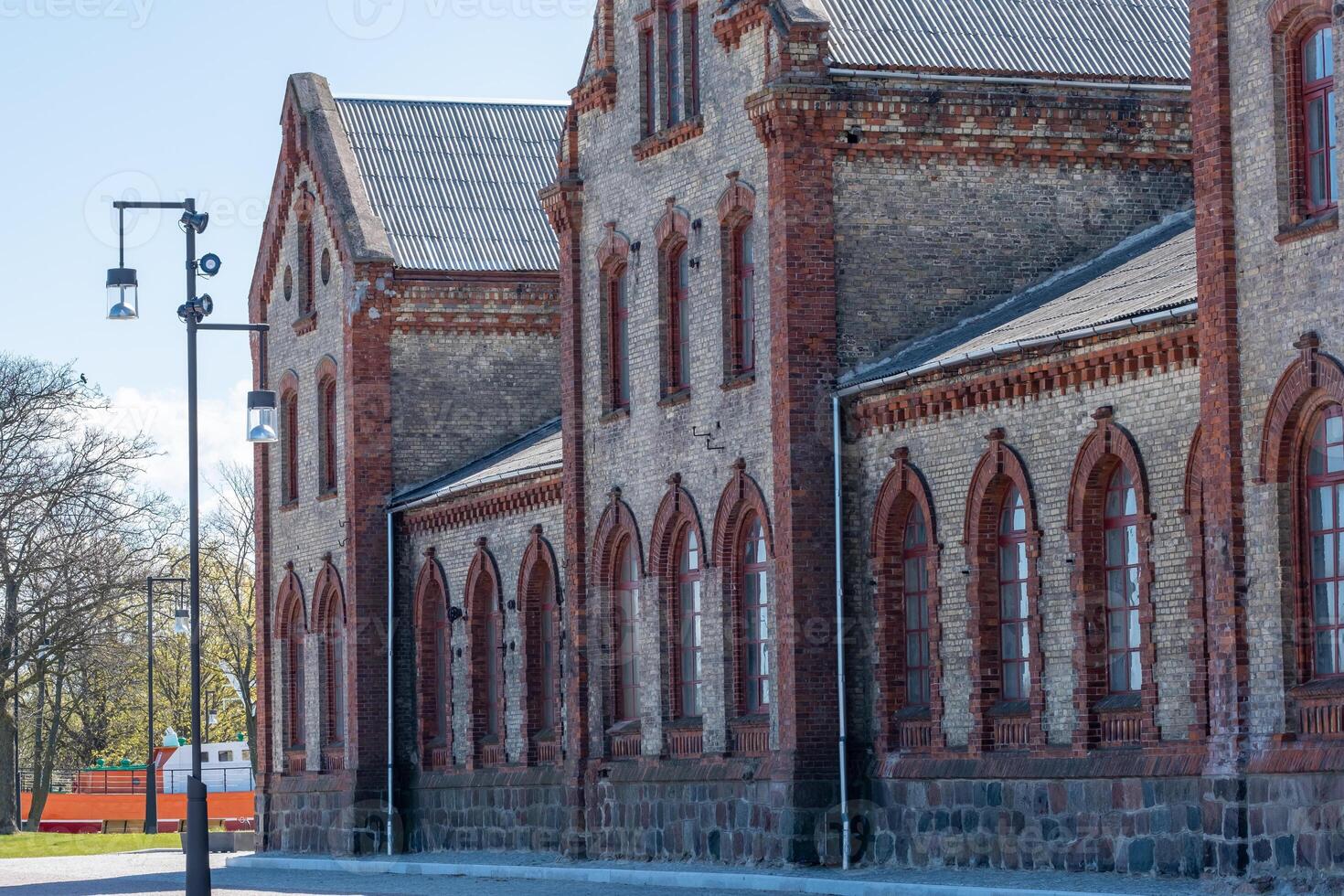 Old, historic brick buildings with beautiful, romantic stained glass windows photo