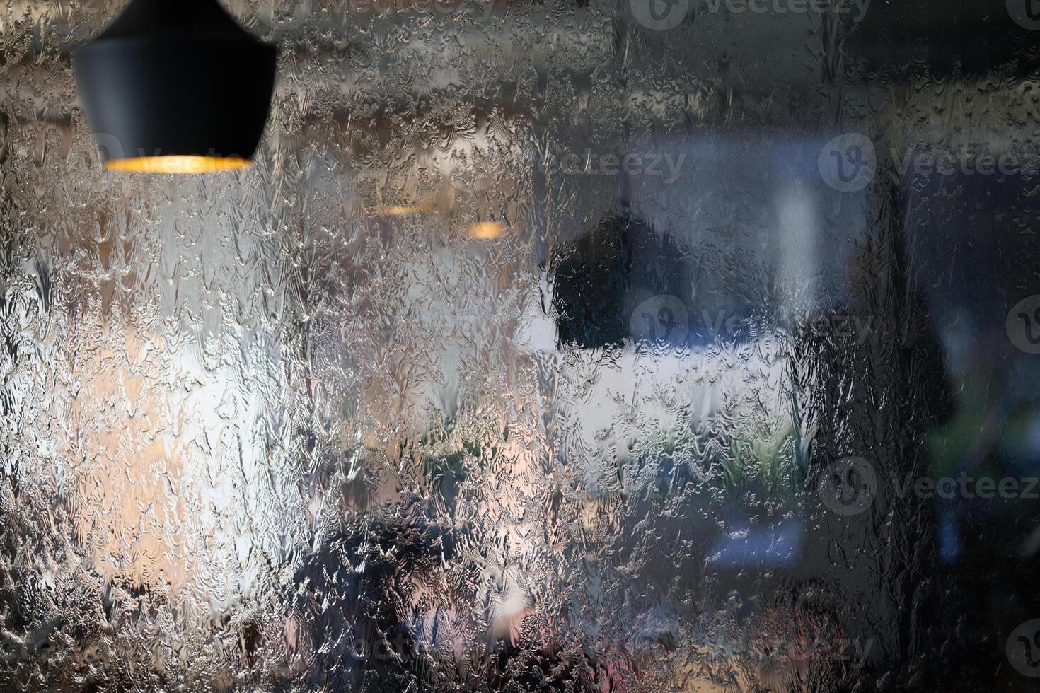 In a close-up capture, the texture of glass through which water flows is beautifully depicted, showcasing intricate patterns and the fluidity of movement in a mesmerizing display photo
