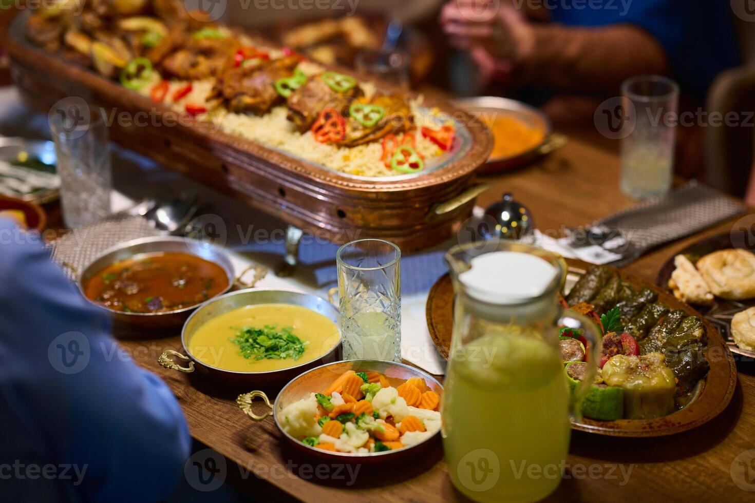 In this captivating aerial view, delicious food adorned with Ramadan decorations, including dates and meat, awaits the arrival of an European Islamic family, promising a festive and flavorful iftar photo