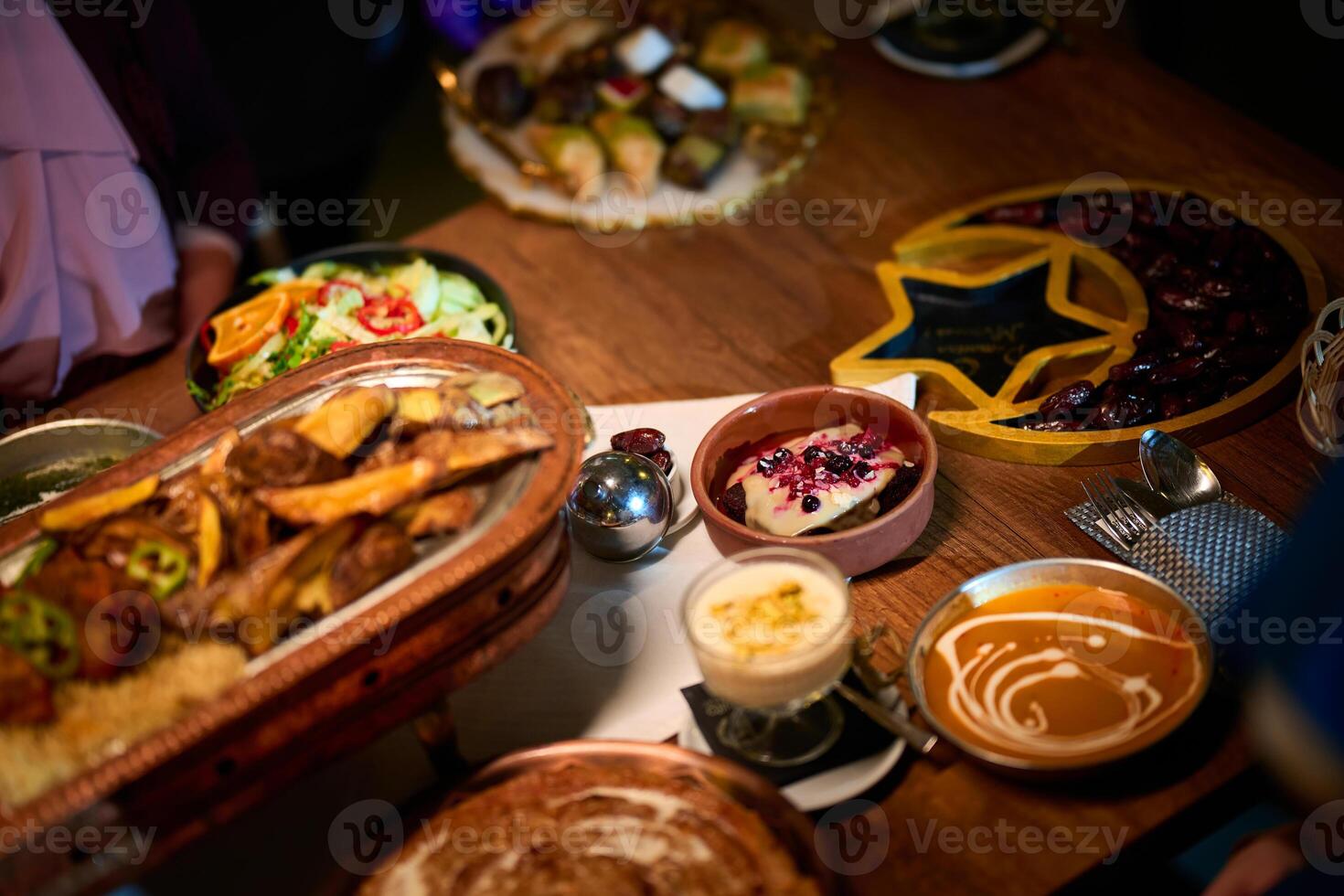In this captivating aerial view, delicious food adorned with Ramadan decorations, including dates and meat, awaits the arrival of an European Islamic family, promising a festive and flavorful iftar photo