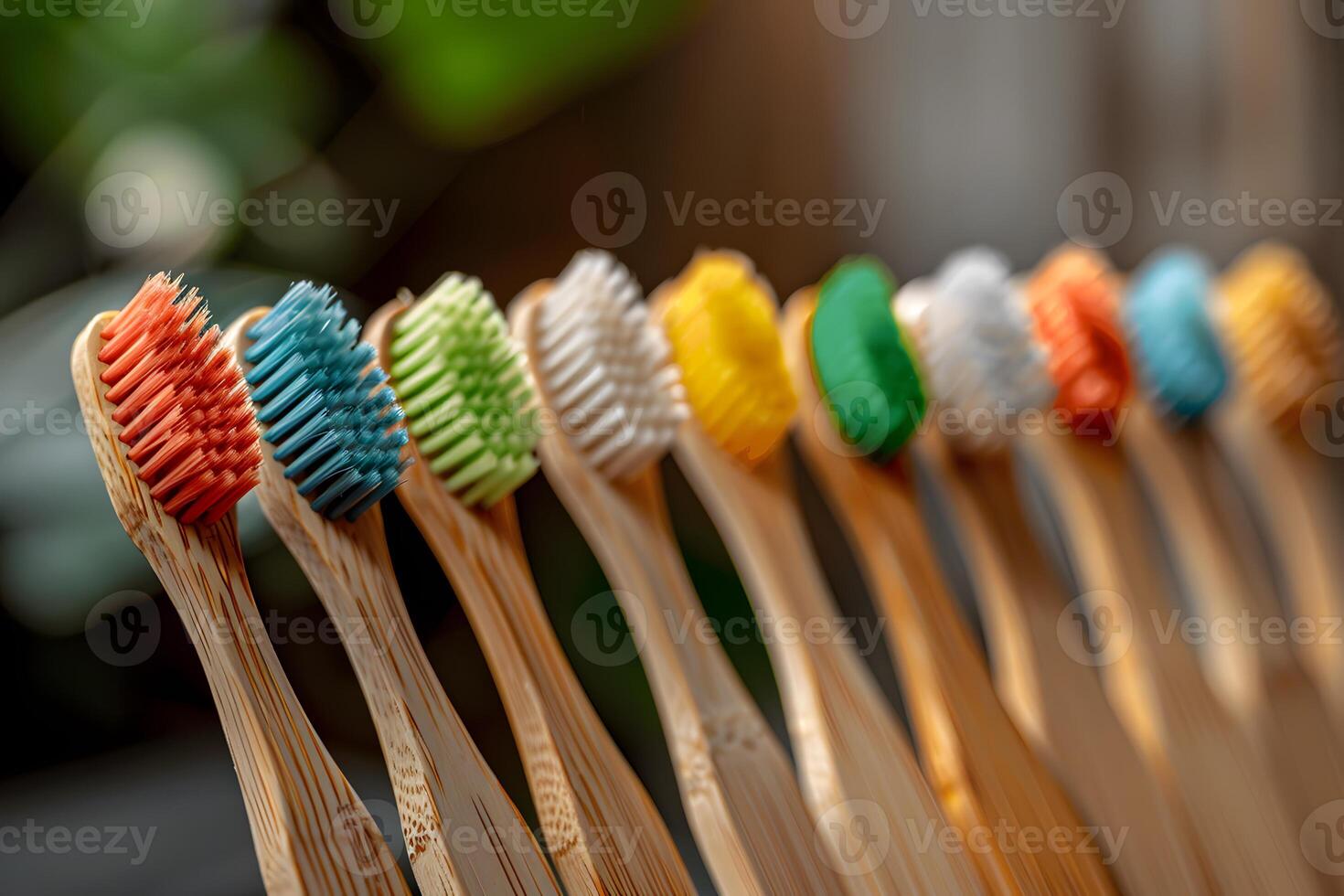 Many toothbrushes lined up on table photo