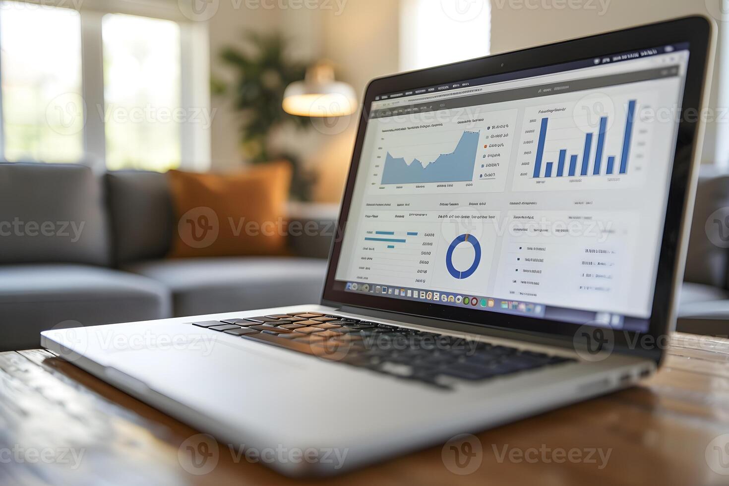 Laptop on a table with a couch in the background photo