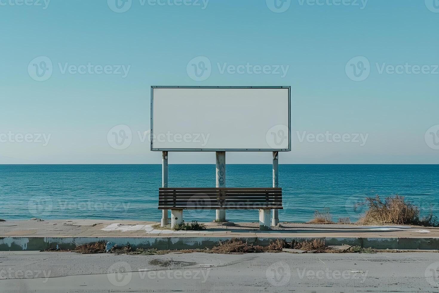 An empty bench on the side of the road by the water photo
