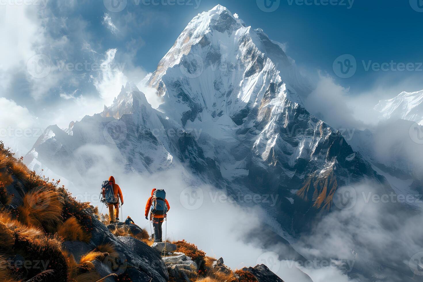 Two people hiking up snowy mountain with view of another snow mountain photo