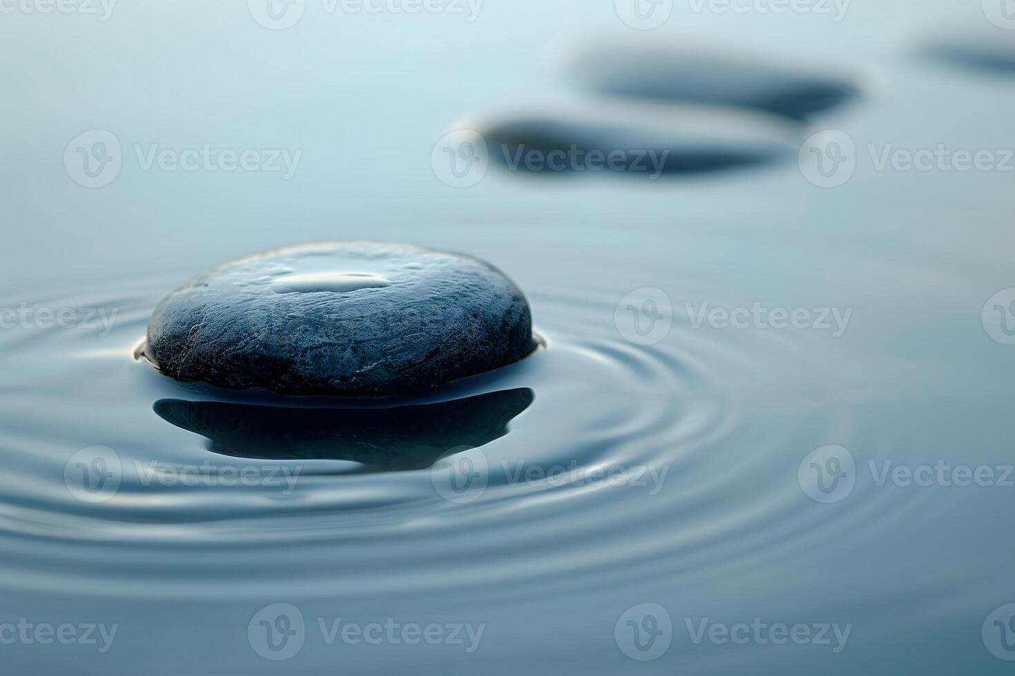 Close up of a stone in the river with ripples photo