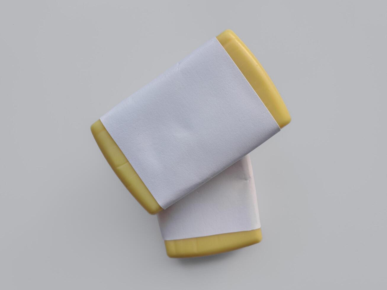 Yellow soap with blank label with color on gray background photo