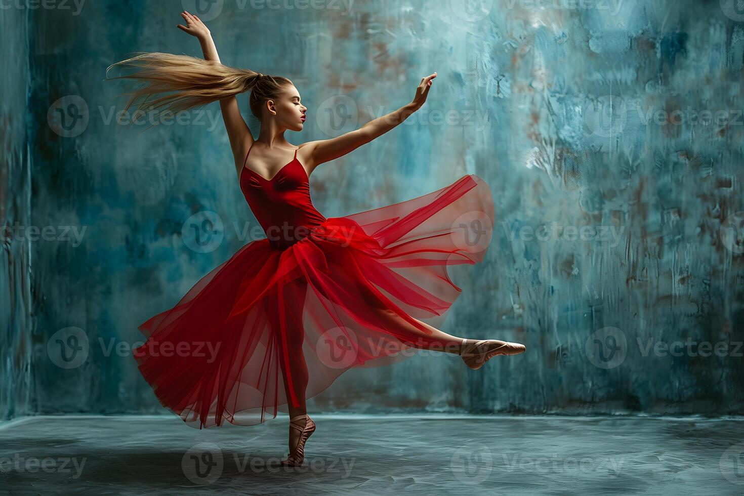 Woman in red dress dancing gracefully in a dance studio photo