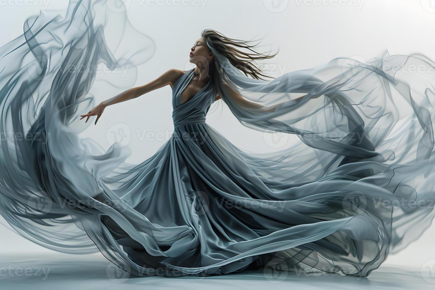 Woman in blue dress dancing with hair flowing photo