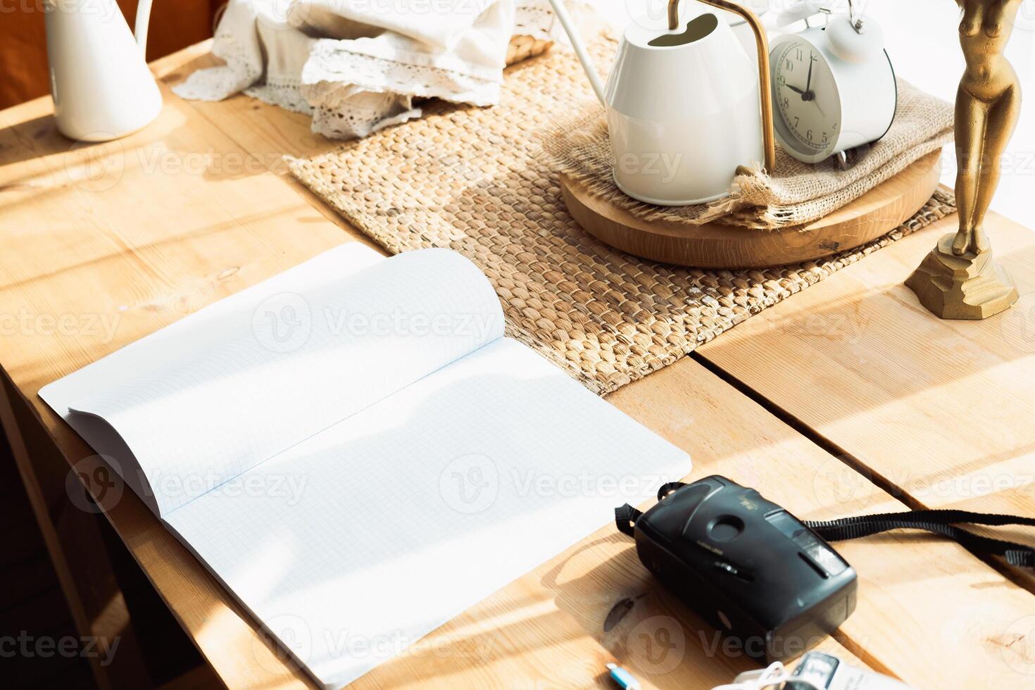 student desk with open notebook and film camera photo