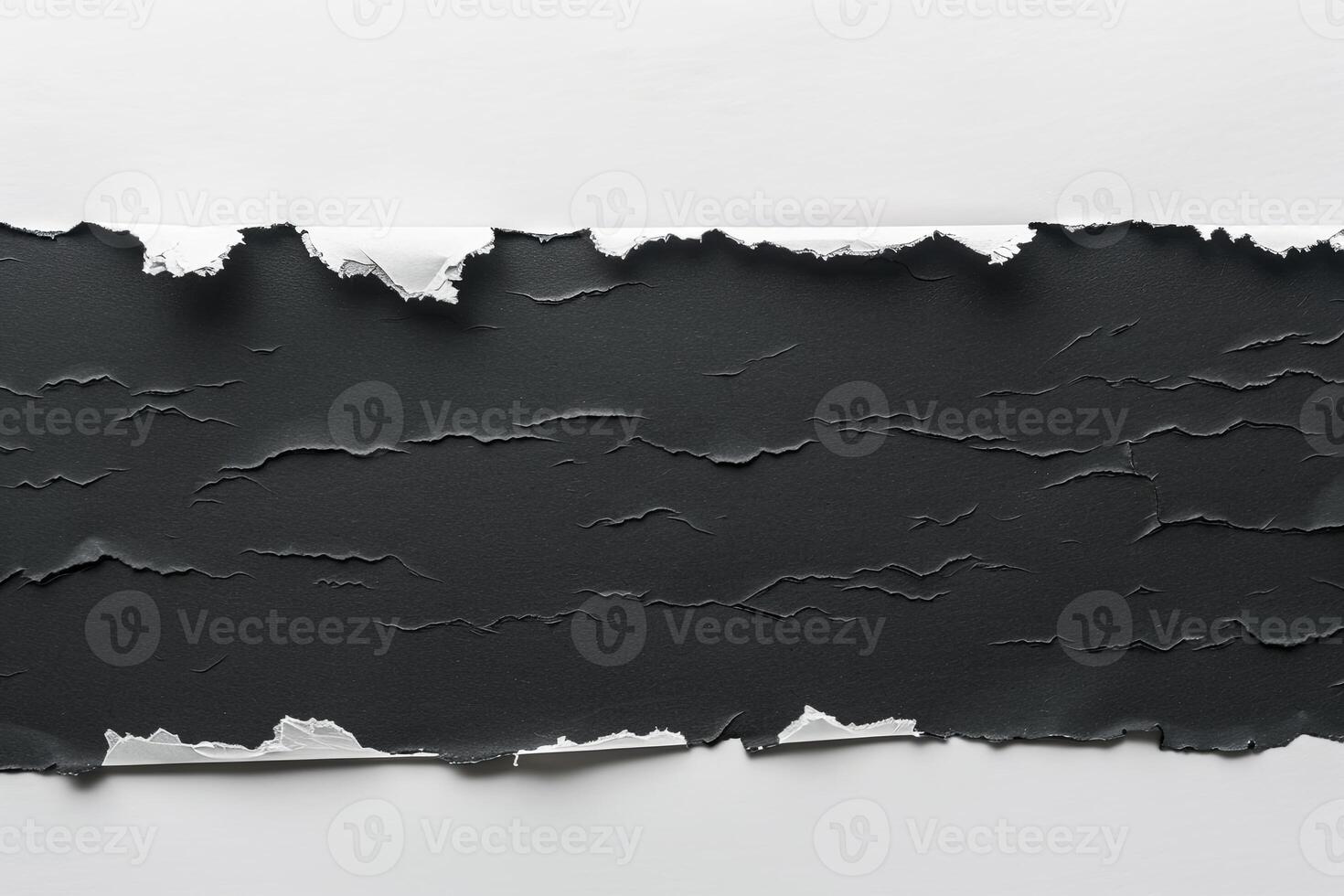 Ripped black paper in flat lay arrangement on clean white background. Torn banner concept photo