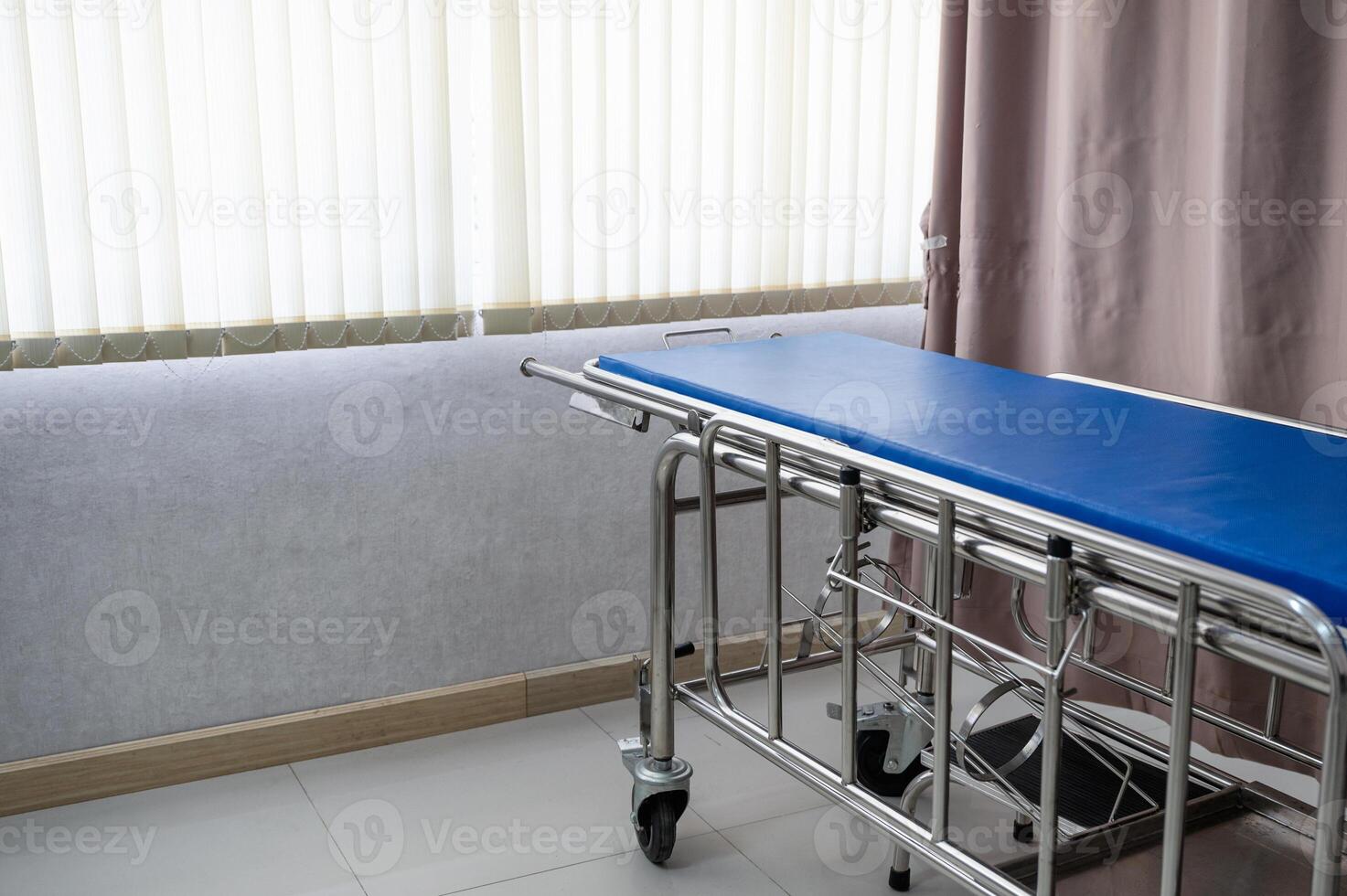 Patient stretcher trolley parked in ward at hospital photo