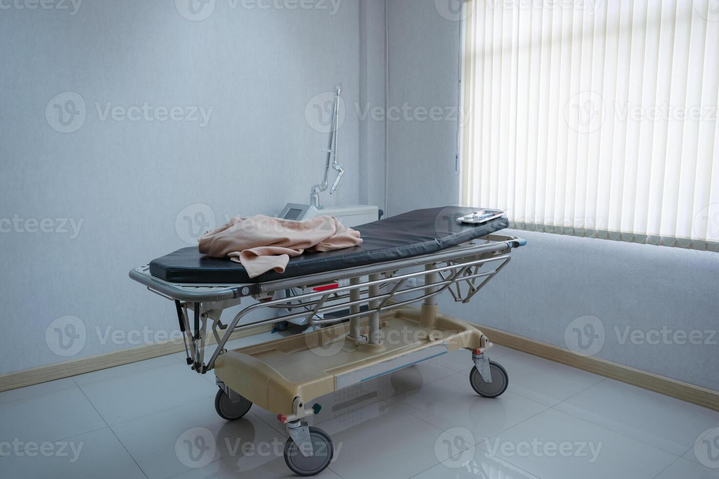 Patient stretcher trolley parked in ward at hospital photo
