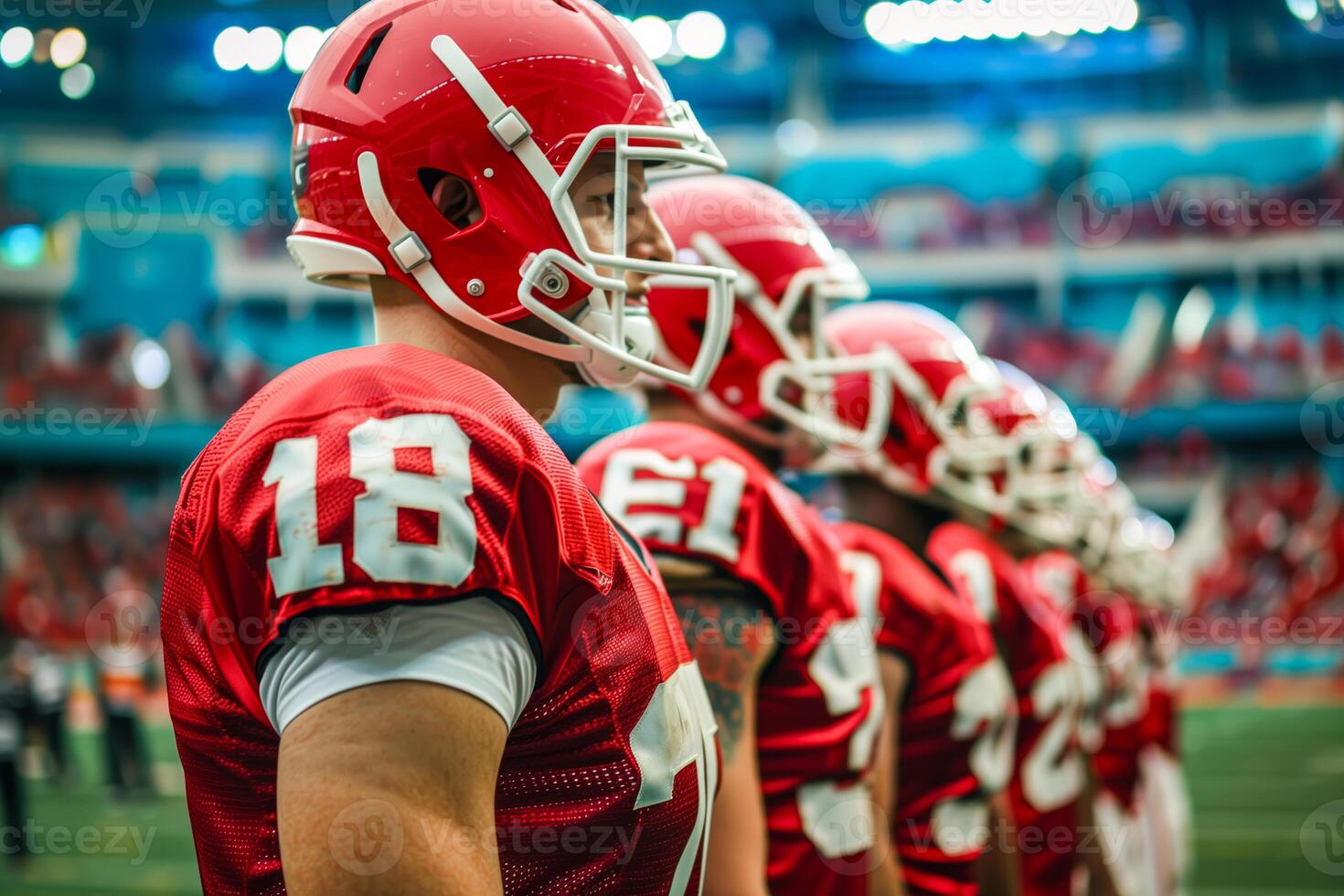 Football players in red uniforms standing on the field photo
