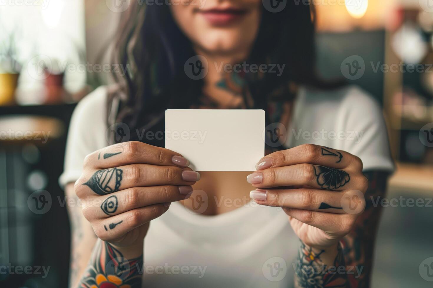 Woman holding a blank card in her hands photo