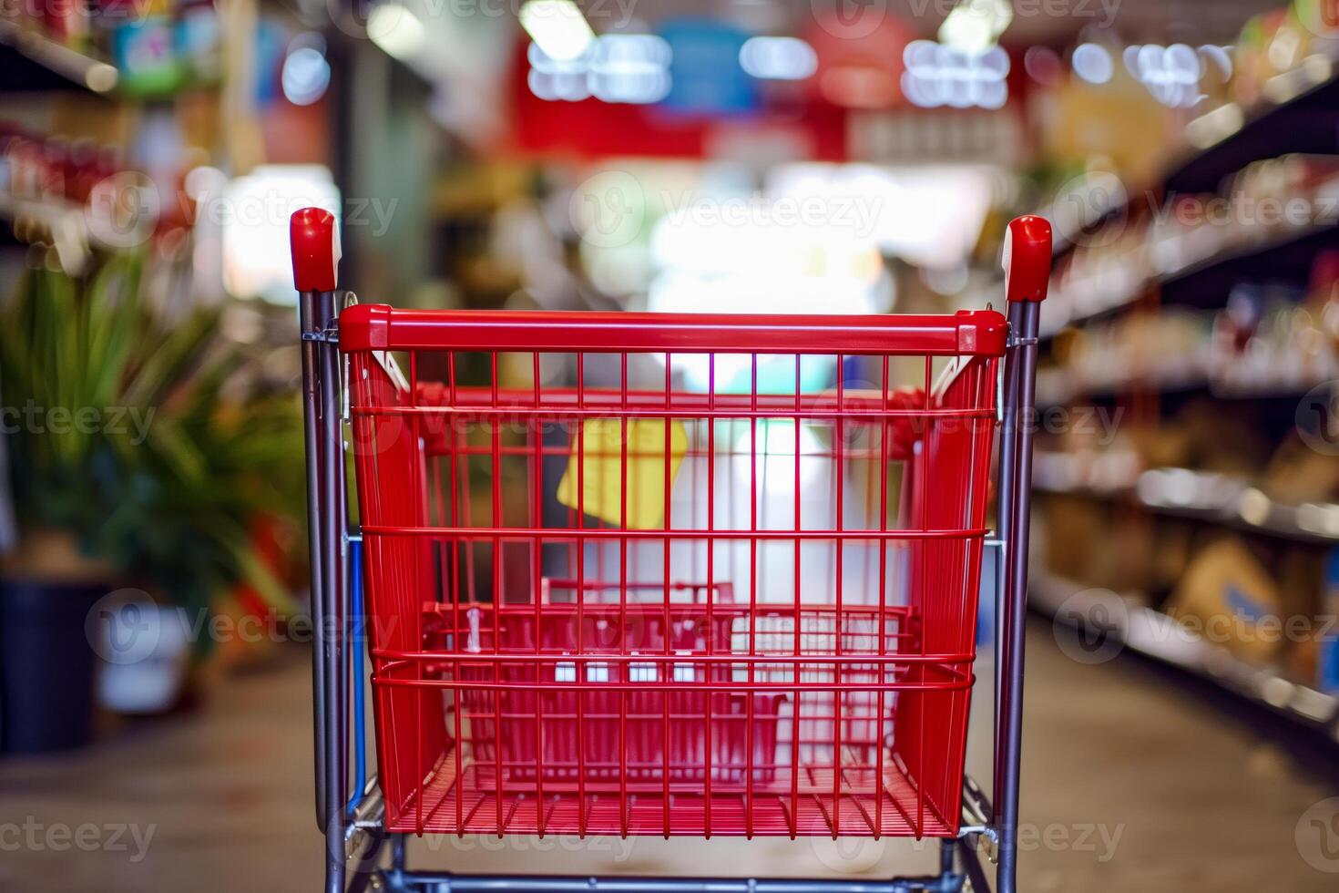 Shopping cart in a store aisle with shelves of goods photo