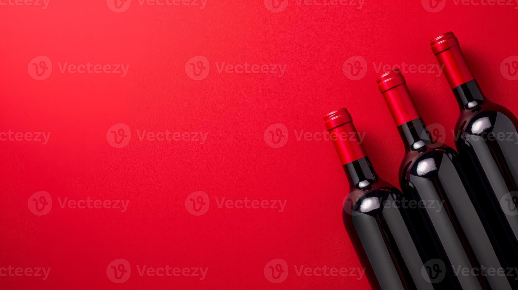 Three bottles of wine on red table photo