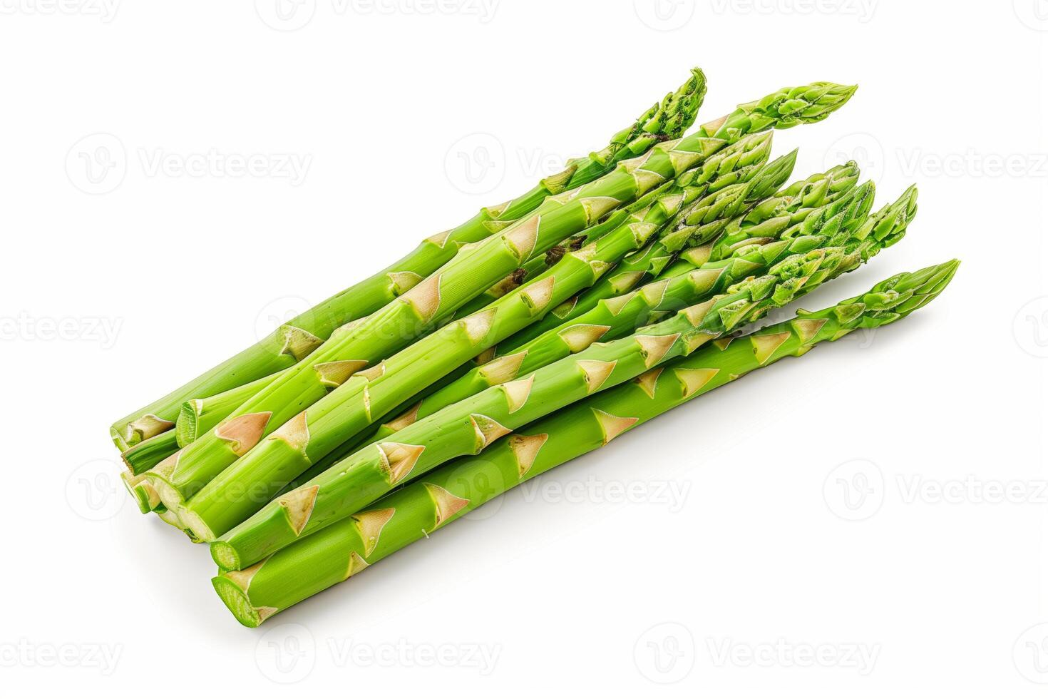 Close up of fresh asparagus spears on white surface photo