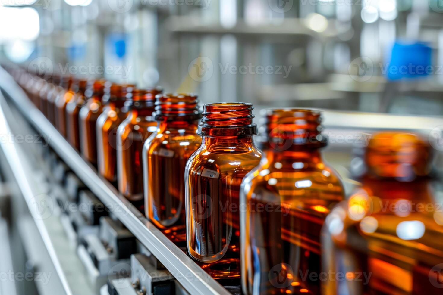 Bottles moving on a factory conveyor with many bottles photo