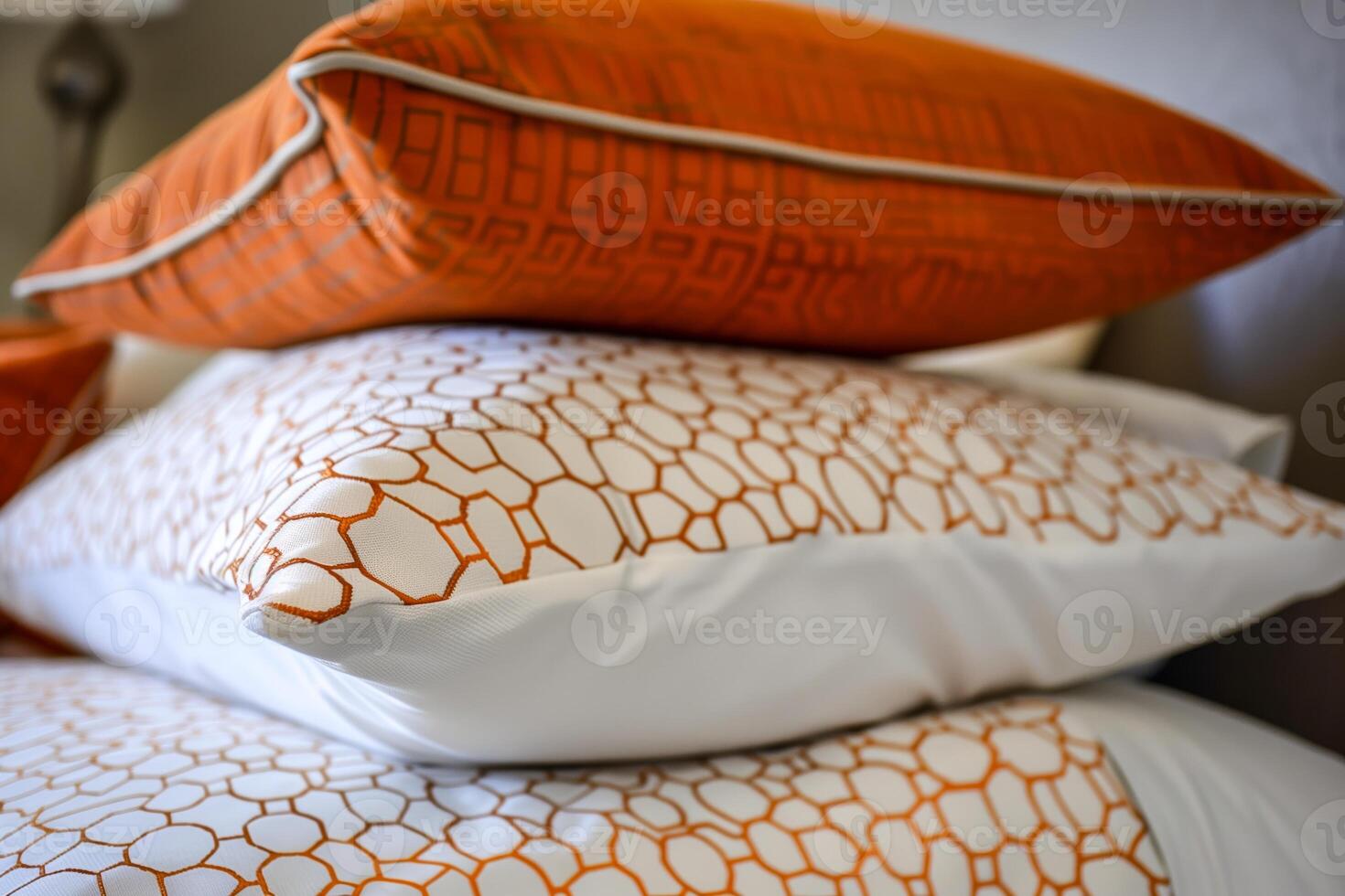 Three pillows stacked on a bed photo