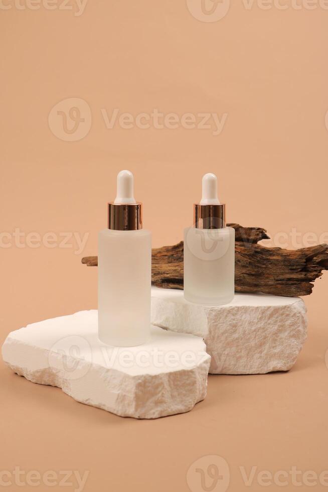 Elegant Skincare Dropper Bottles on Stone Pedestal with Natural Wood photo