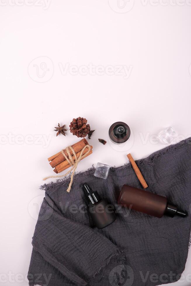 Natural Skincare Dropper Bottles with Botanical Accents on White Background photo