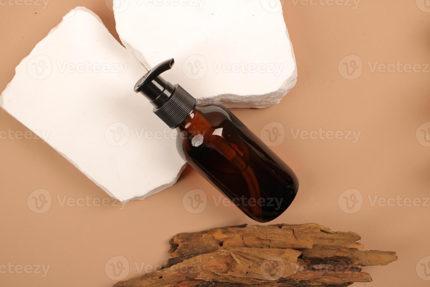 Top View of Amber Pump Bottle on Stone Pedestal with Natural Wood photo