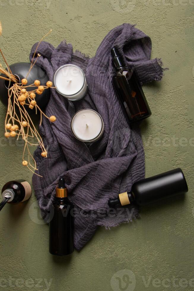 Amber and Black Dropper Bottles with Candles and Dried Flowers for Rustic Decor photo