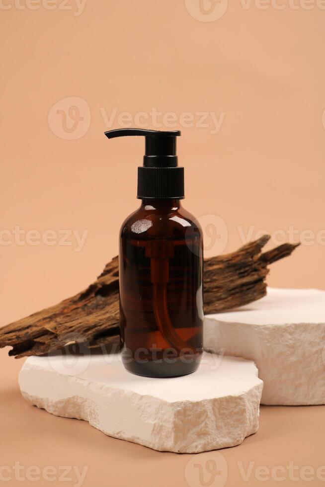 Amber Pump Bottle with Natural Wood on Stone Pedestal photo