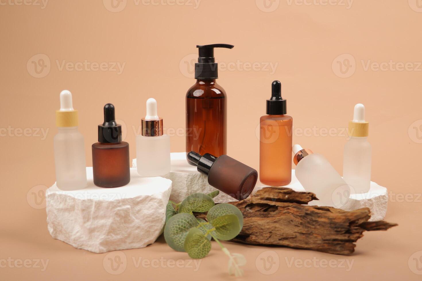 Assorted Skincare Bottles on Stone Pedestals with Natural Wood and Greenery photo
