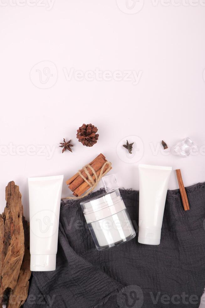 Natural Skincare Products with Botanical and Wooden Accents on White Background photo