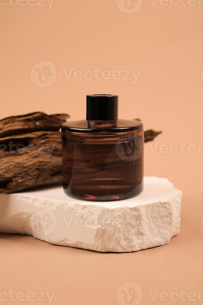 Elegant Amber Glass Bottle on Minimalist Stone Platform photo