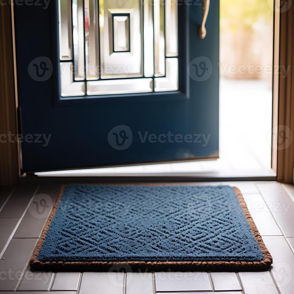 Close-up of blue doormat in front of door. photo