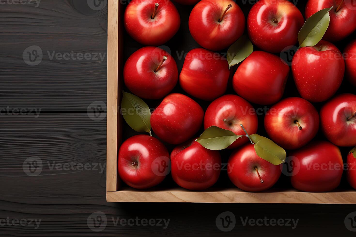 Wooden box with fresh red apples on wooden background, top view photo