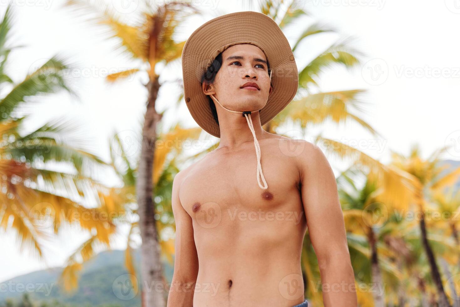 Muscular Asian Man Enjoying a Tropical Beach Vacation in a Happy Summer Portrait photo