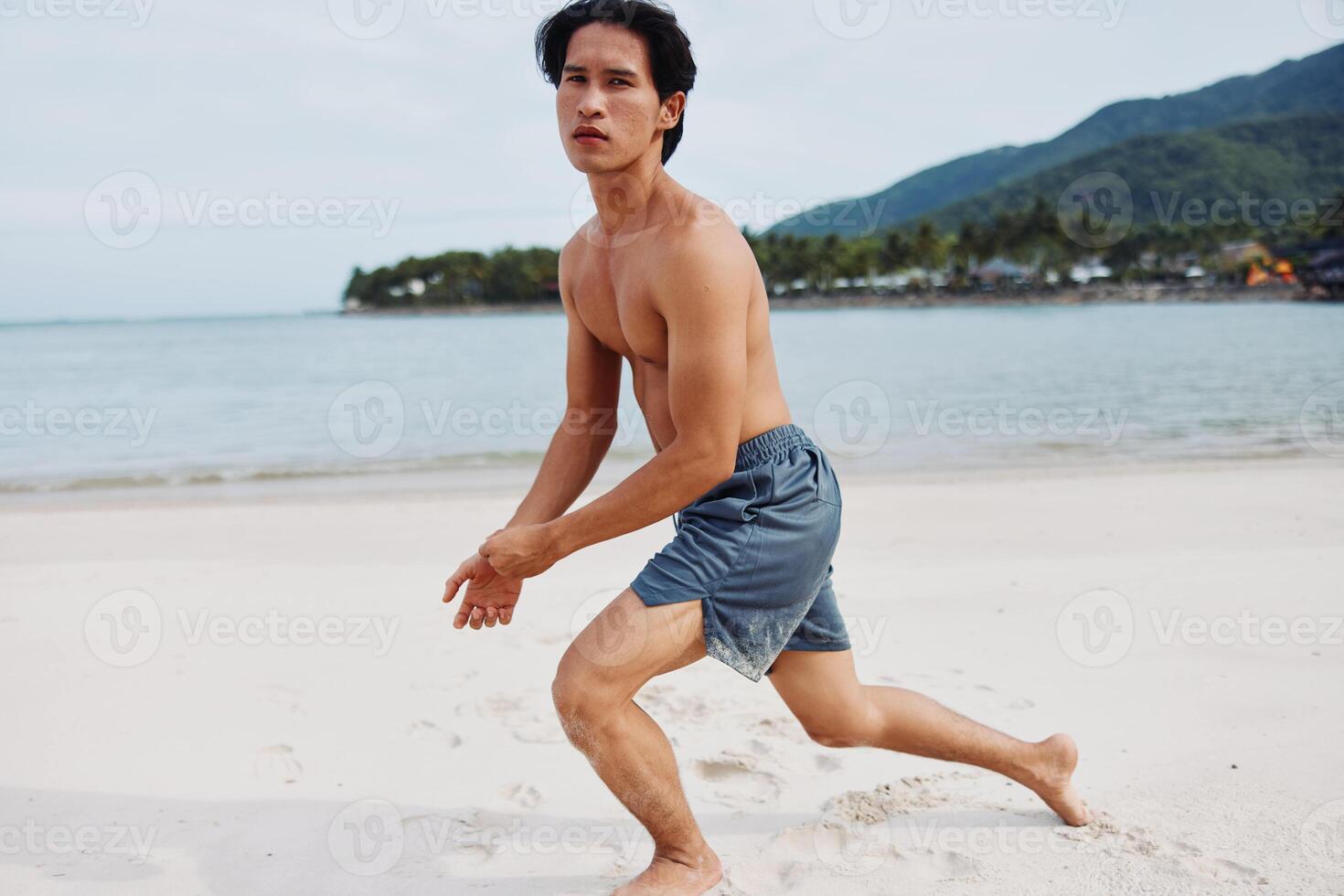 Muscular Asian Athlete Running on the Beach, Fueling Fitness in Lifestyle photo