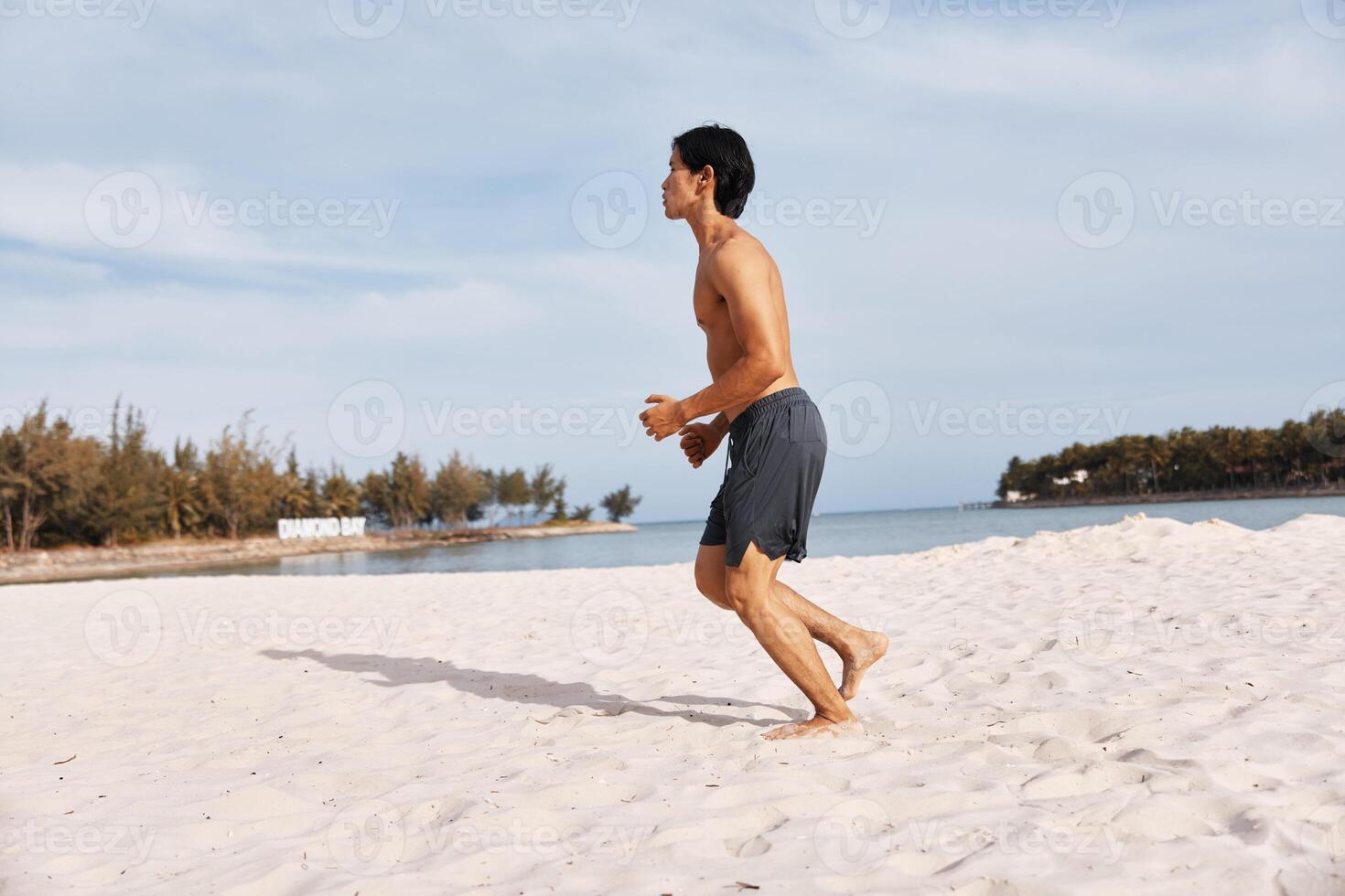 Muscular Asian Man Enjoying a Tropical Beach Vacation - Abs of Paradise photo