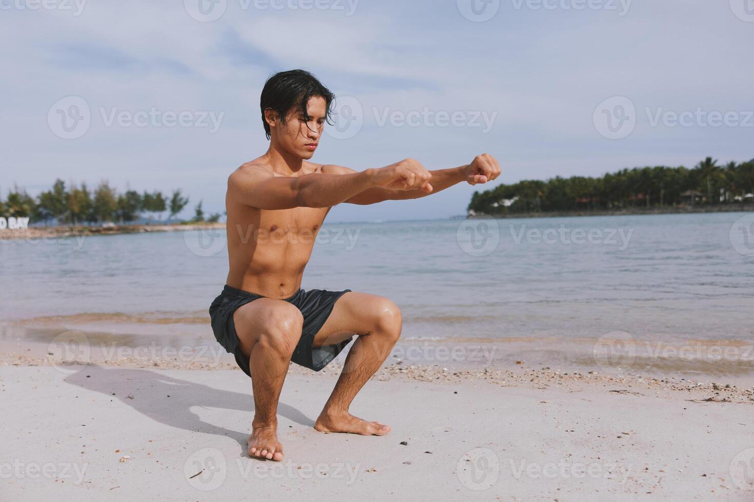 Active Asian Athlete Running on the Beach. A Muscular Man enjoying Fitness and Freedom in a Summer photo