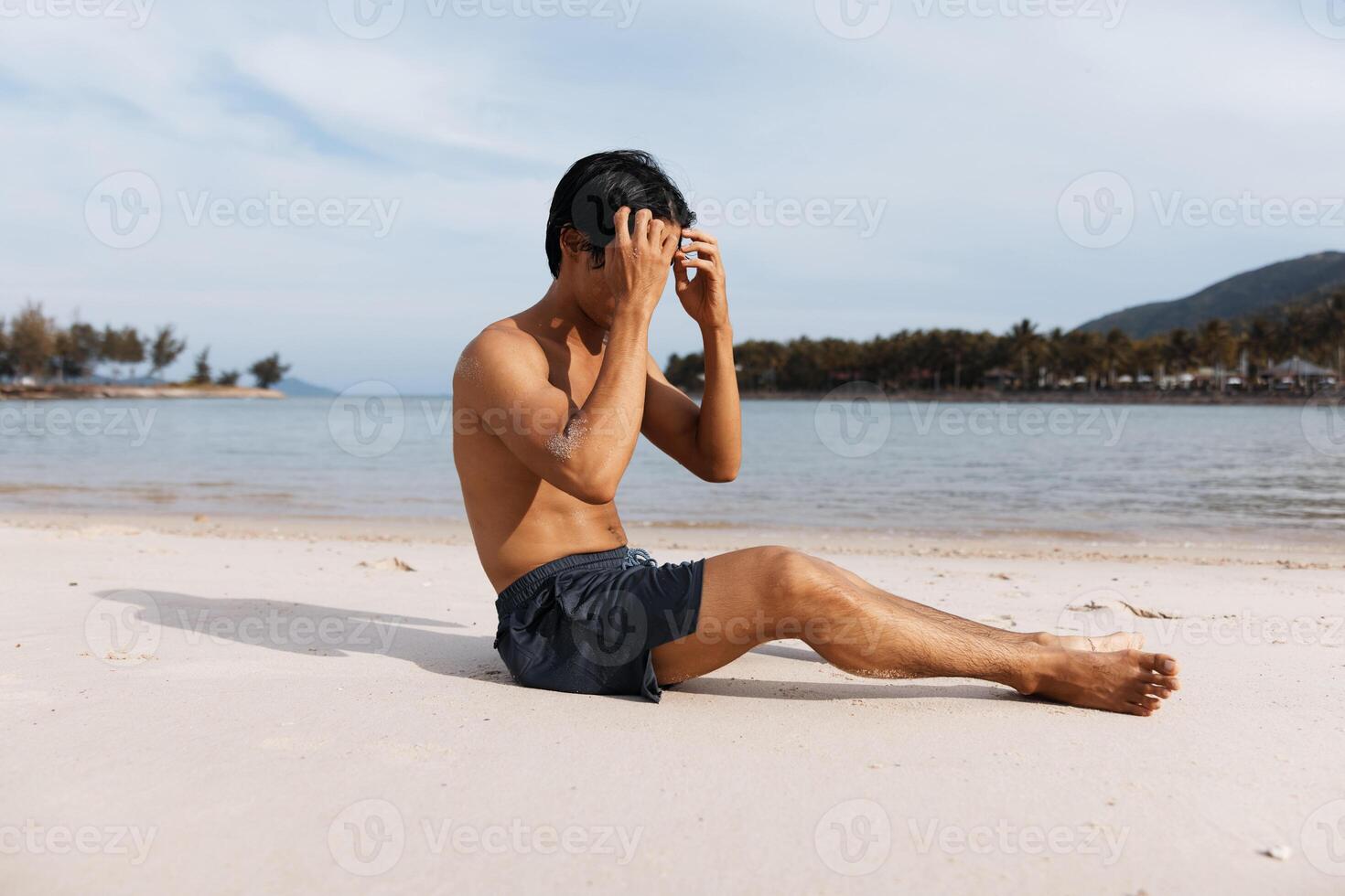 Active Asian Man Running on the Beach, Exuding Strength and Freedom amidst the Serene Ocean Sunset photo