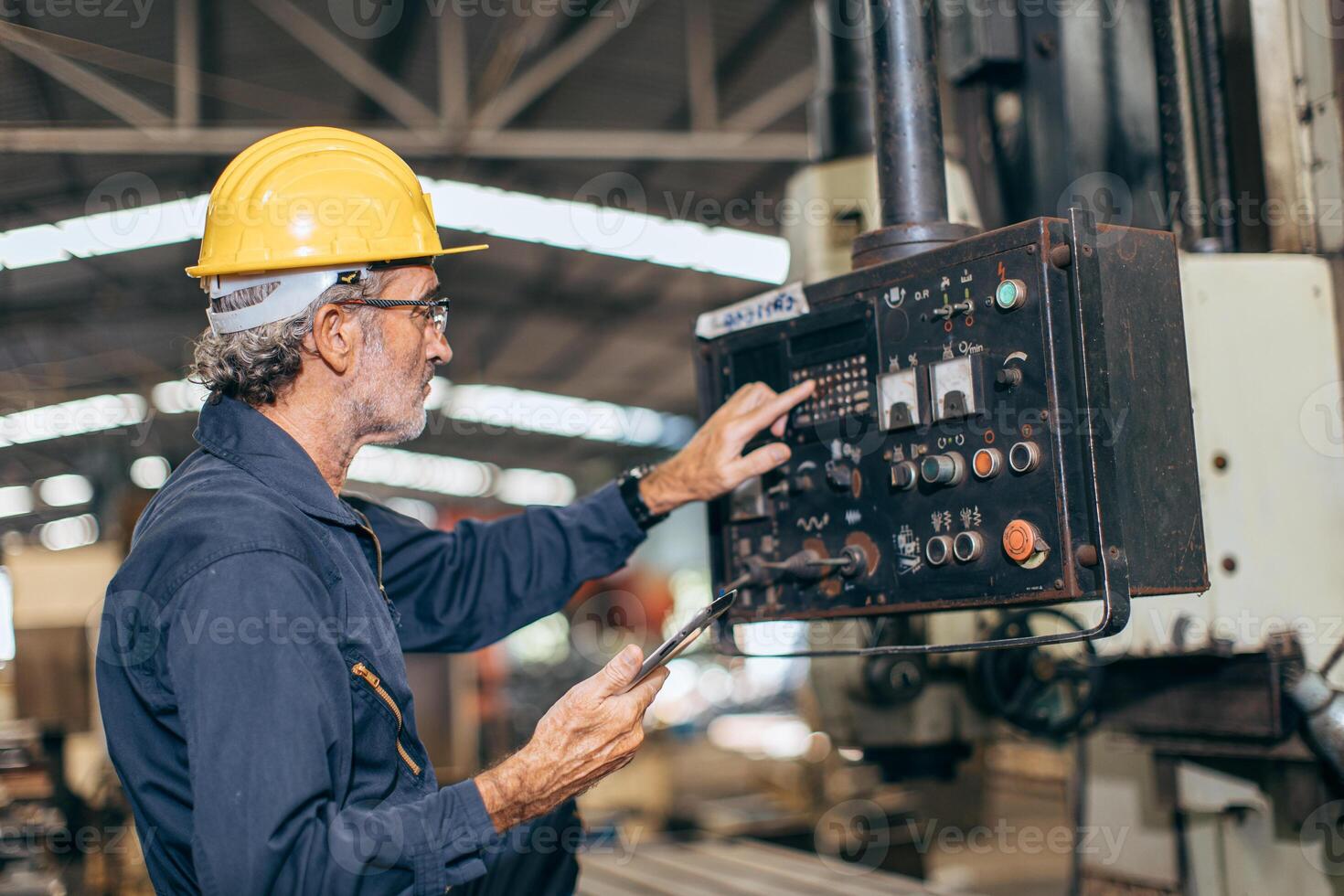 senior professional engineer working control operate program CNC milling machine in heavy industry factory photo