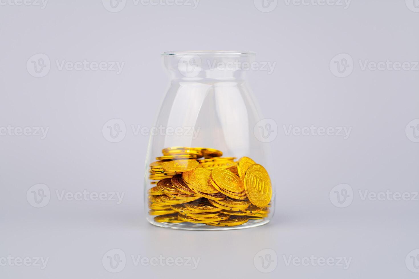 Gold coins in glass jars, high exchange rate investment and gold stocks photo