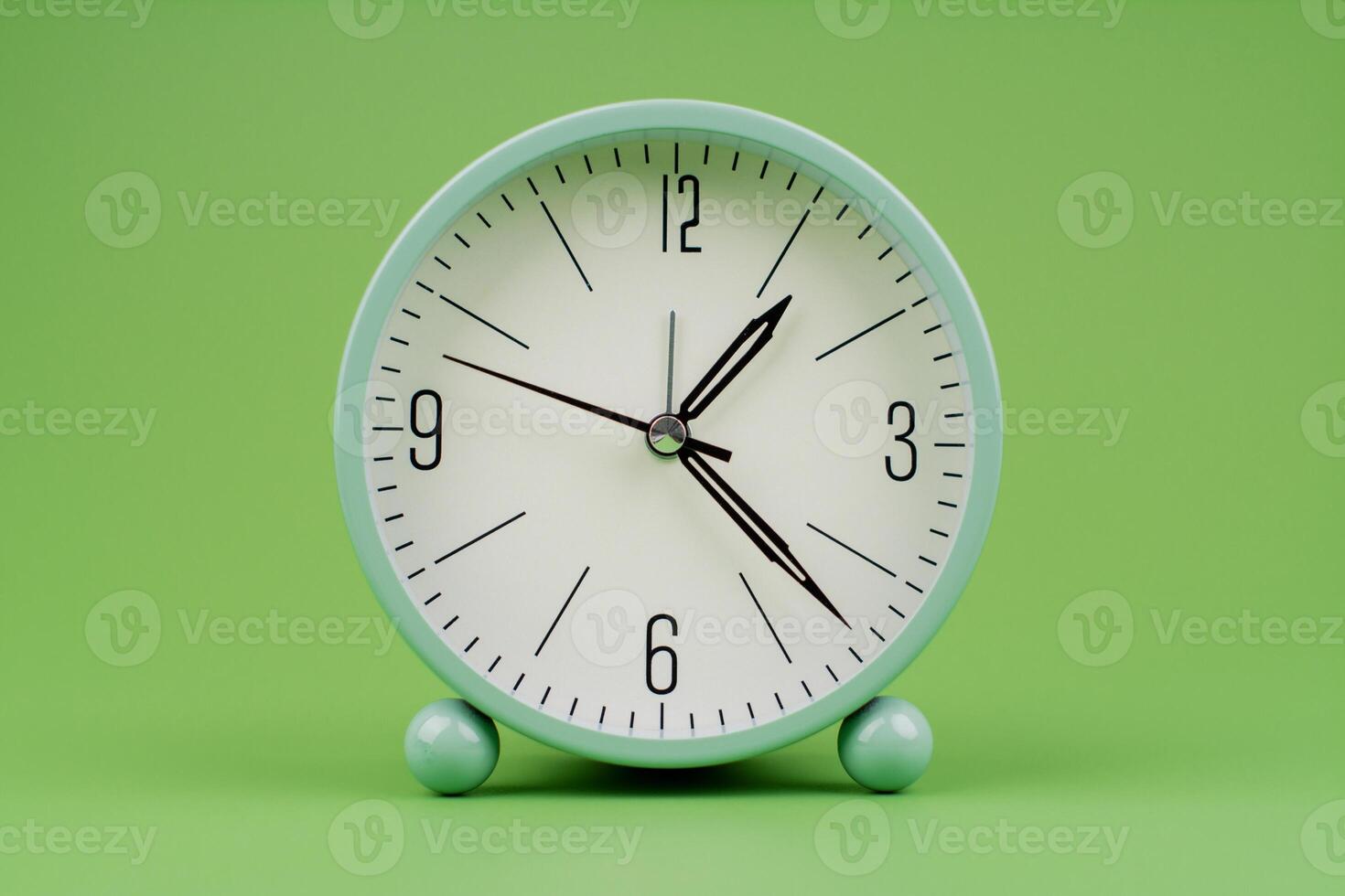 Time, standing still, time hand, photo of a moving clock on a green background, time concept.