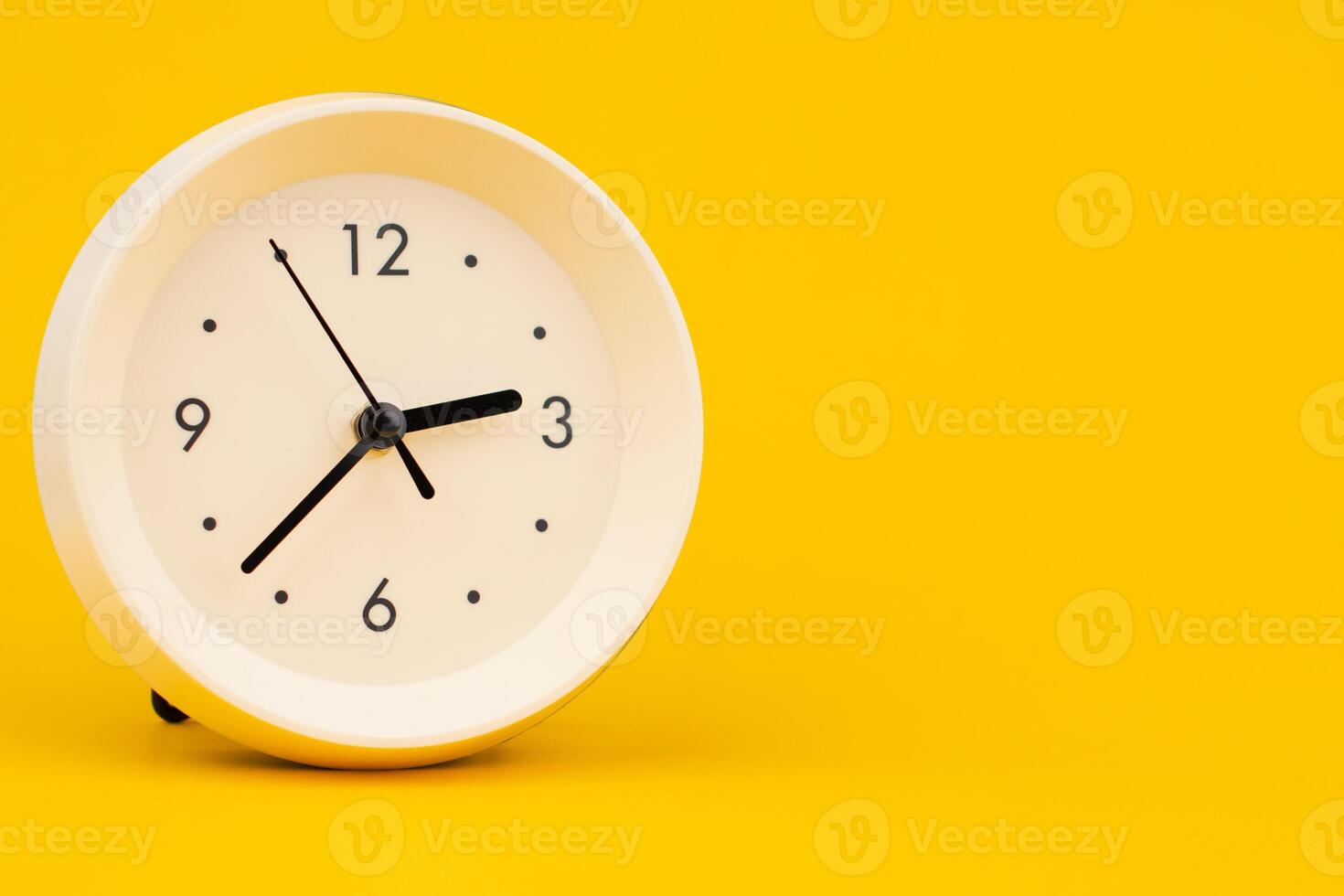 Clock on a yellow background, working with time and planning life, studio photo