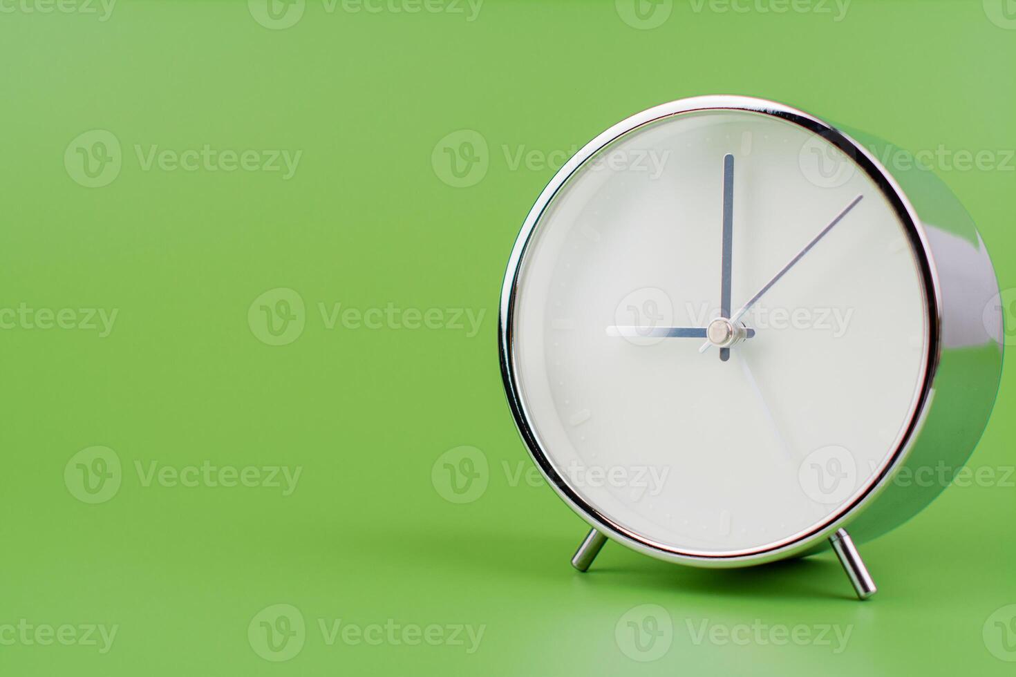 Time, standing still, time hand, photo of a moving clock on a green background, time concept.