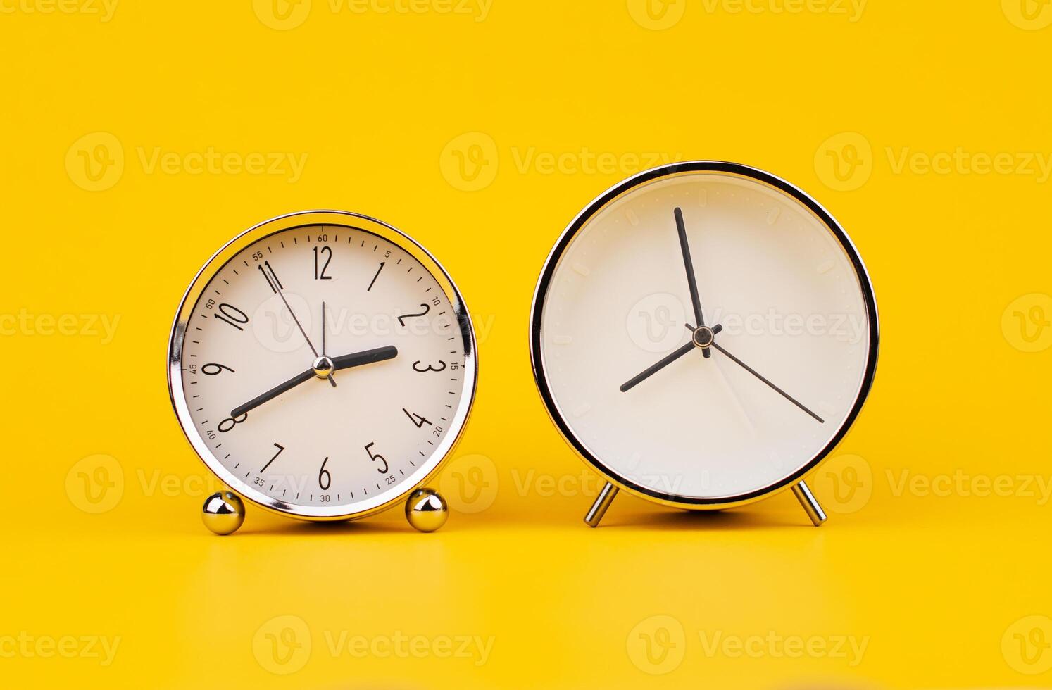 Time and work, the clock stops, the minute hand stops moving, a photo of a clock on a yellow background.